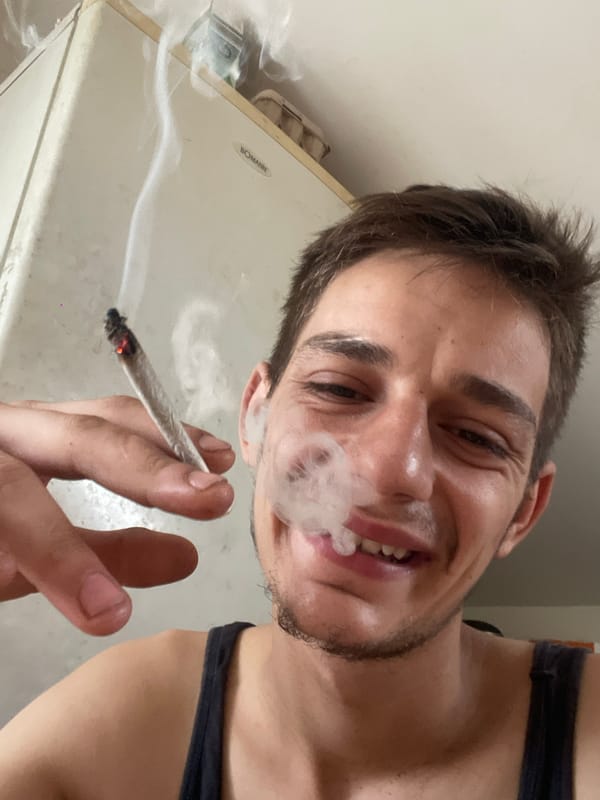 Smoking and chilling indoors with juice and cannabis nearby.
