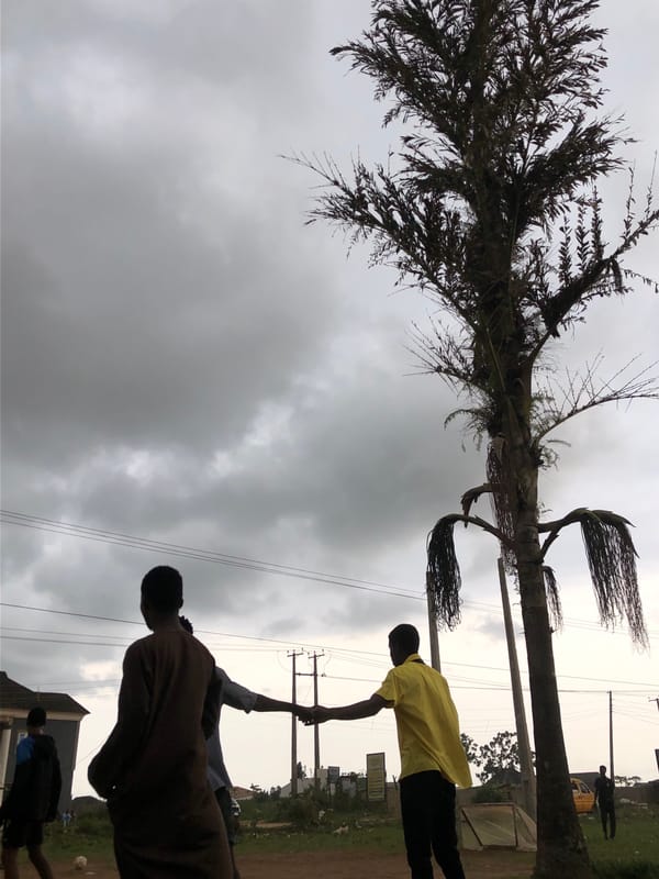 Young men play casual soccer under stormy skies