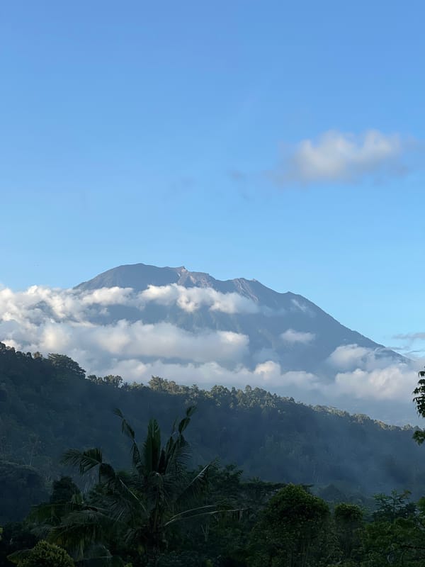 Mount Agung viewed through clouds from Sidemen, Indonesia