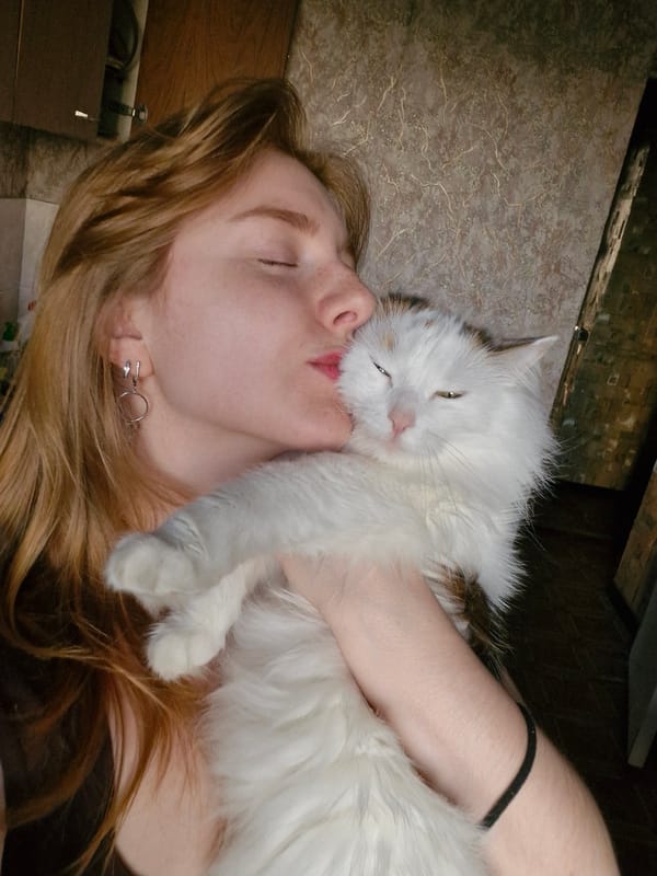 Woman shares quiet afternoon moments with white cat in Yekaterinburg