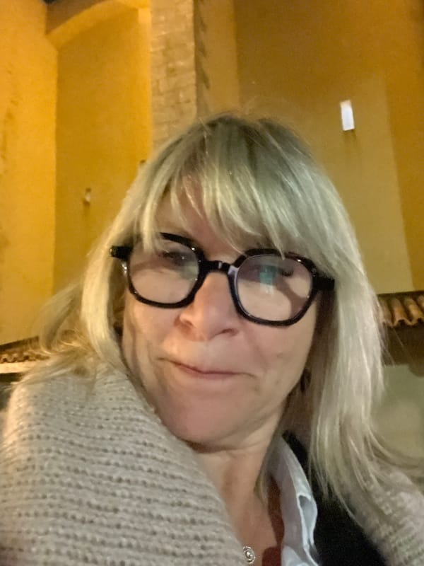 Woman photographs herself at Grimaud marina near luxury yacht