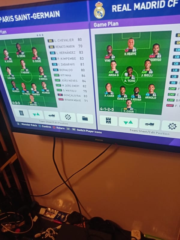 Person plays football video games on PlayStation during evening session