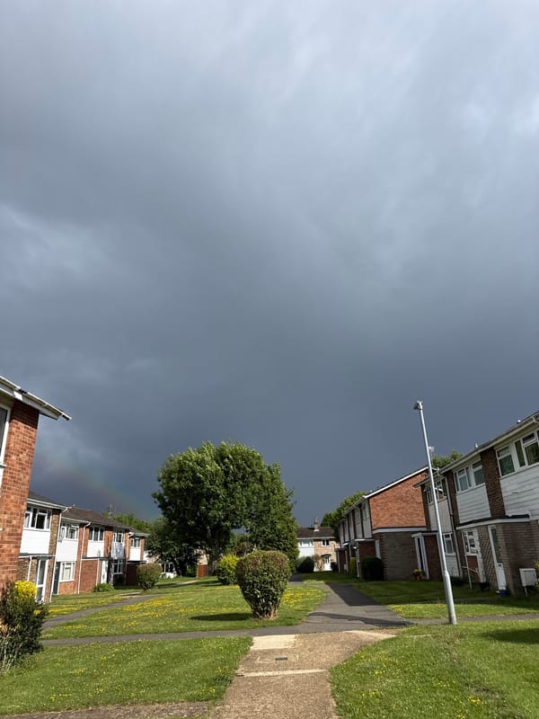Child with umbrella walks through stormy Hazlemere streets