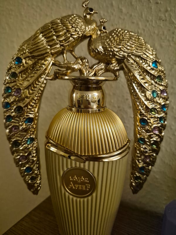 Gold peacock perfume bottle and decorative collectibles, multiple angles