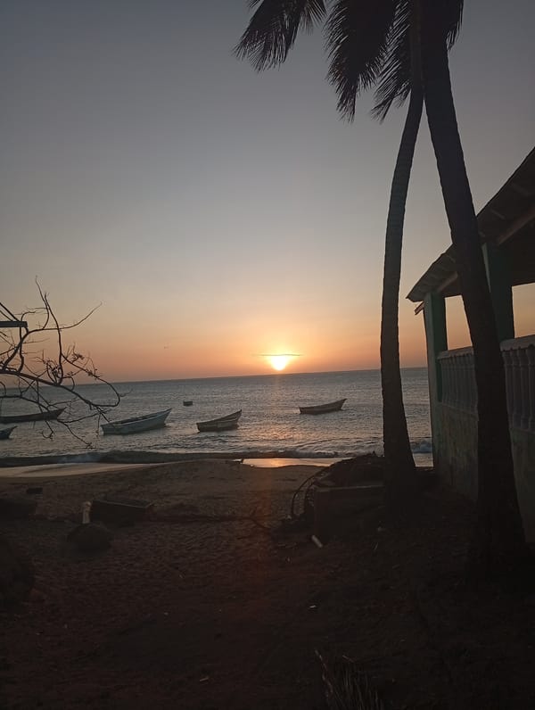 Sunset captured at Juan Griego beach with boats, palm trees