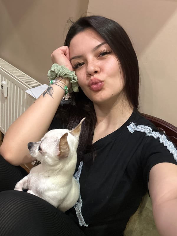 Woman poses with white dog in casual photo session