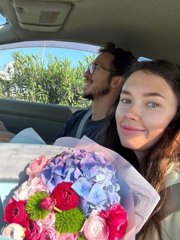 Couple shares sunny moment with flower bouquet in Cyprus