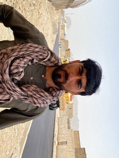 Road construction underway in Kandahar with local residents observing
