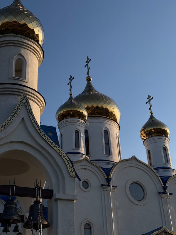 Orthodox church with golden domes photographed in Novopokrovskaya