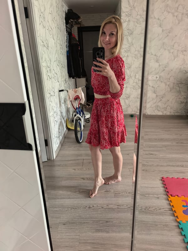 Woman takes mirror selfies in red floral outfit, Sterlitamak
