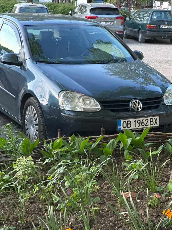 Blue Volkswagen parked near garden in Lovech, Bulgaria