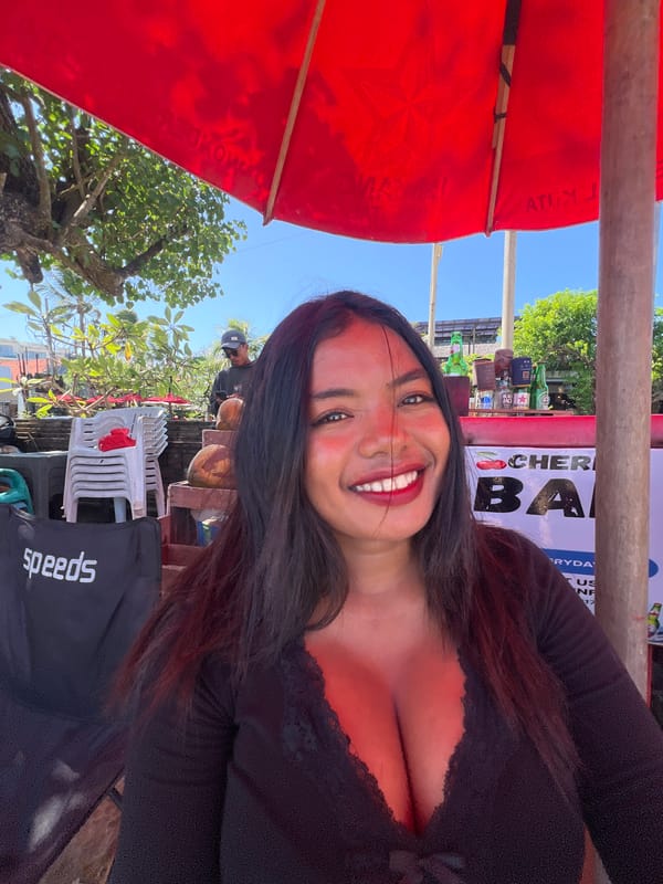 Kuta Beach in full swing: surf, vendors, and shoreline crowds