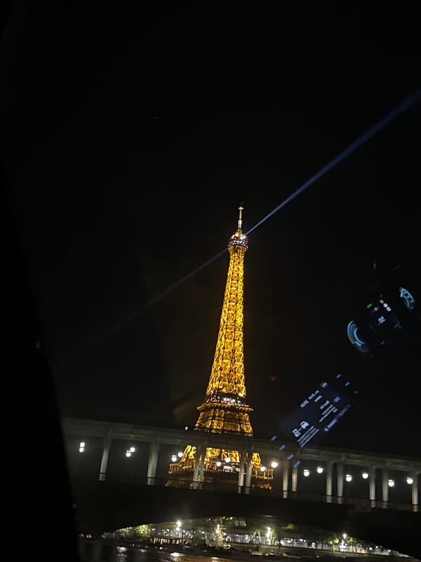 Eiffel Tower beacon illuminates Paris night sky