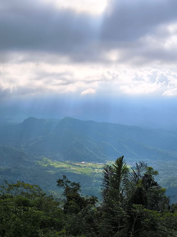 Wooden observation platform documented overlooking mountains near Abang, Indonesia