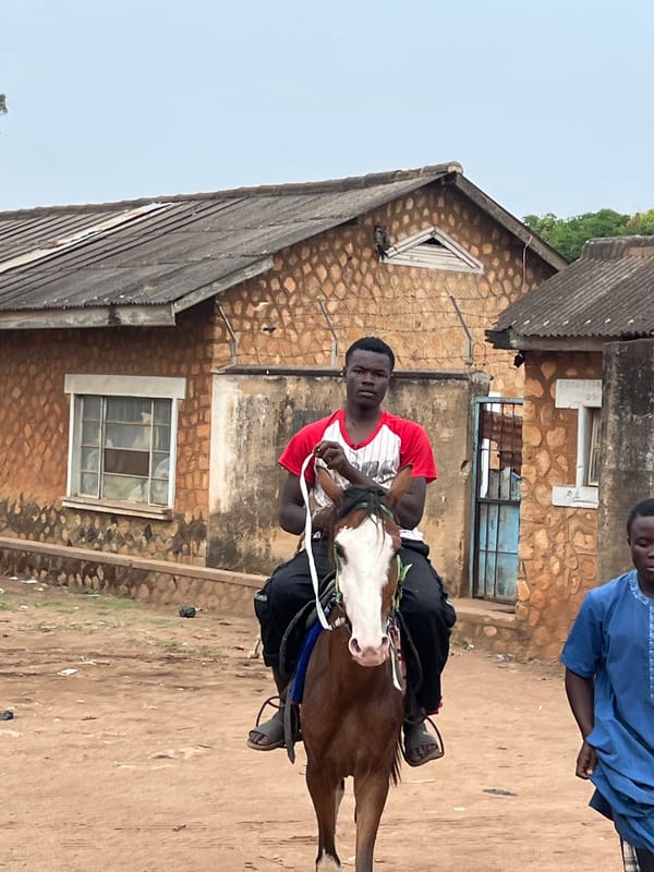 Man rides horse in Bukuru, Nigeria