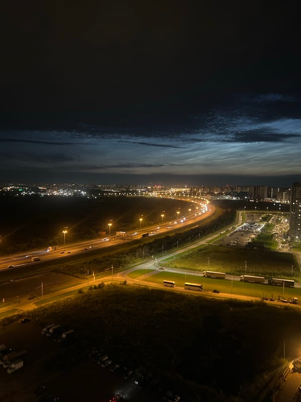 Nighttime aerial views of a city grid and highway interchange.