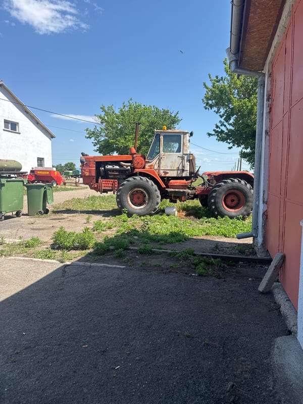Farm machinery parked in rural Bulgarian village storage area