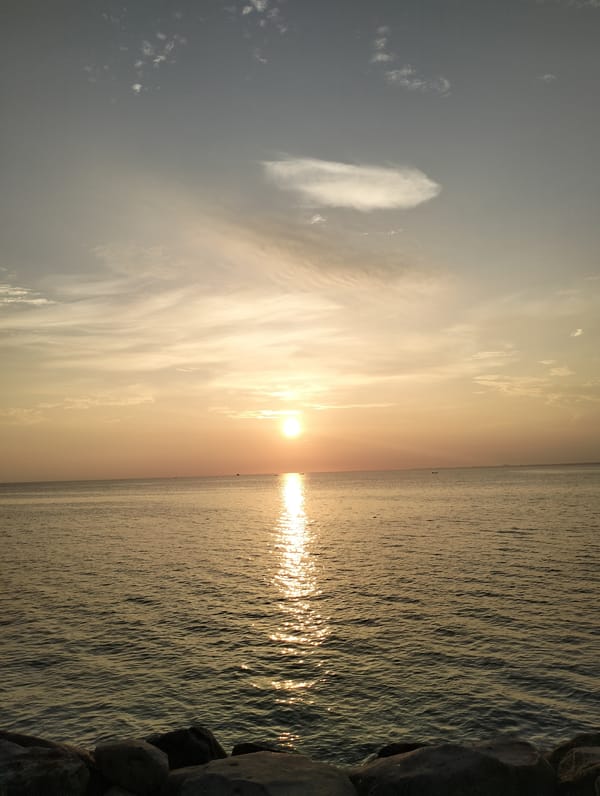 Sunset documented over ocean waters in Lhokseumawe, Indonesia