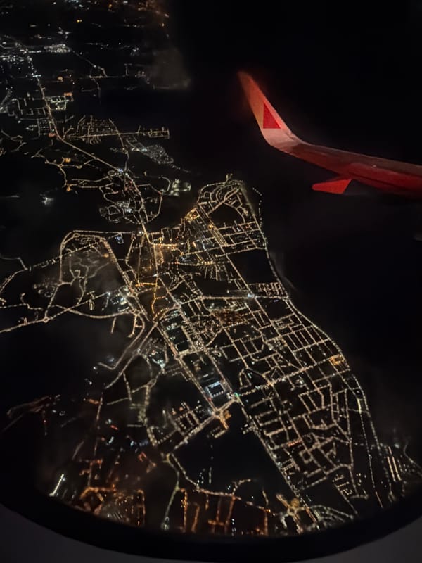 Aerial nighttime view of illuminated Lisbon captured from airplane