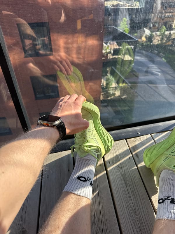 Runner takes rest break on wooden deck in Oslo