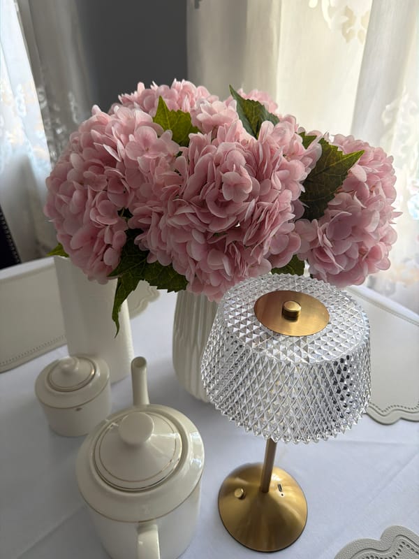 Pink hydrangeas and crystal objects arranged on table in Khimki