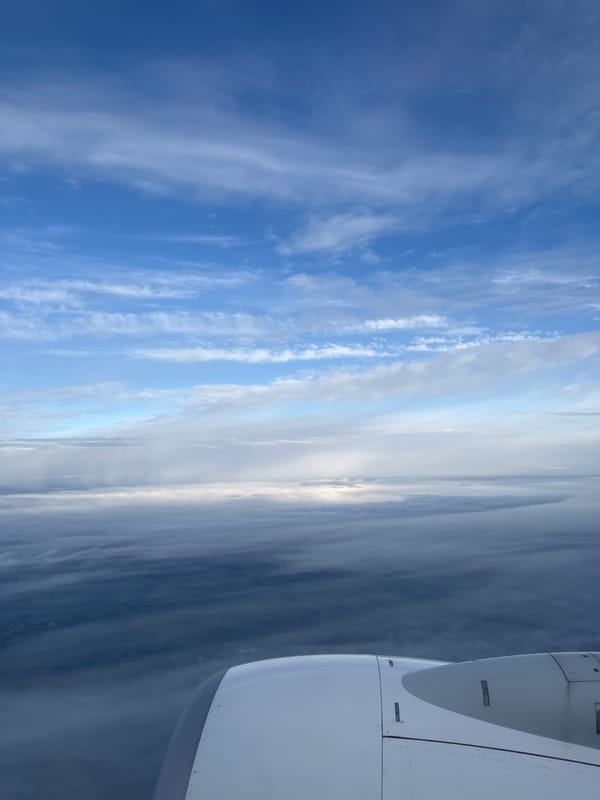 Passenger captures aerial view of clouds from airplane window