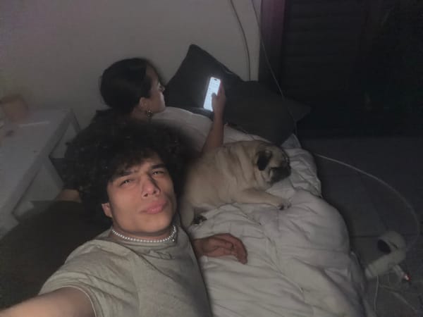 Couple with pug dog captured relaxing at home