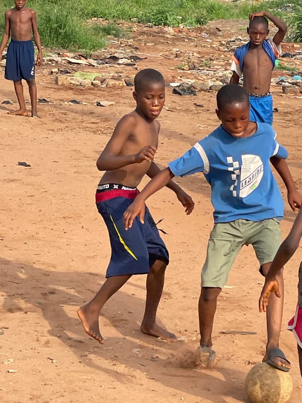 Nigerian children play soccer amid urban life scenes