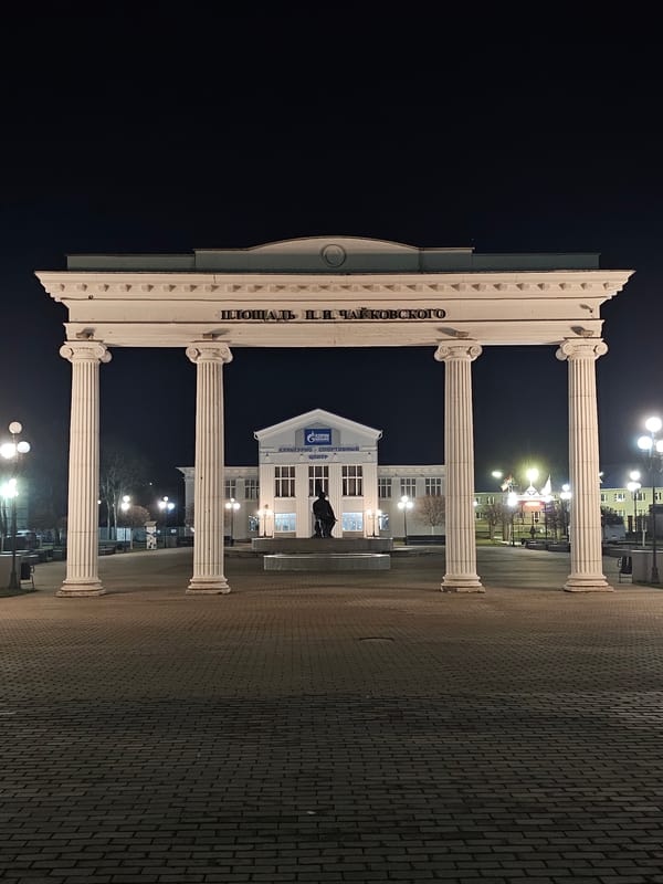 Evening scenes captured: plaza archway, vintage fire engine, twilight waterscape