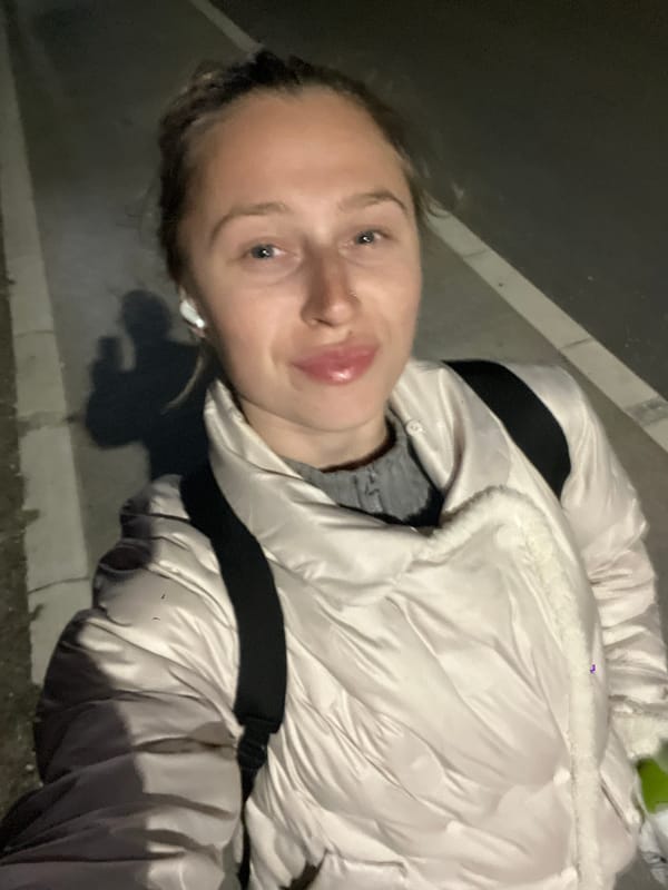 Woman takes selfie in white jacket in Boreti, Montenegro