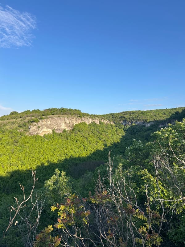Clear skies over green cliffs documented in Krushuna, Bulgaria
