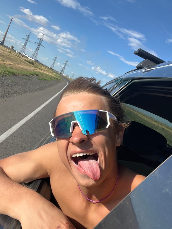 Mirrored shades and open windows on a Kazakhstan road trip