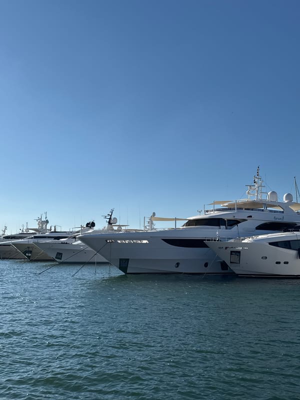 Afternoon at a Greek marina: yachts, naval ships, and ice cream