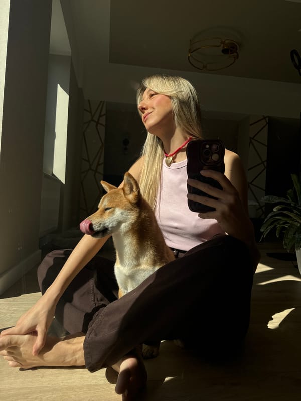 Woman takes selfies with Shiba Inu in sunny Carnikava home