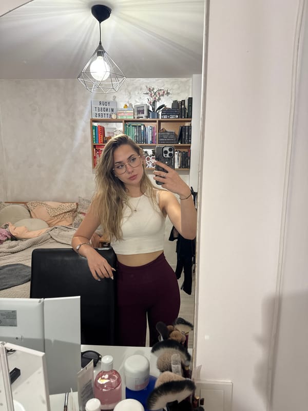 Woman takes mirror selfie with flowers in Blagoevgrad