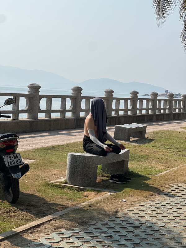 Person meditates on coastal bench in Nha Trang, Vietnam