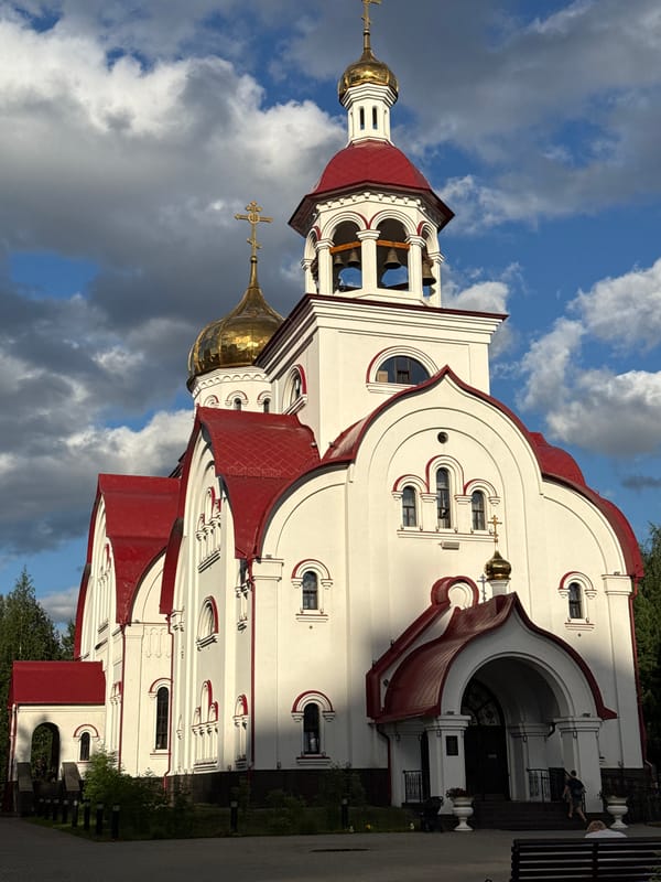 White-walled Orthodox church with golden dome in western Siberia