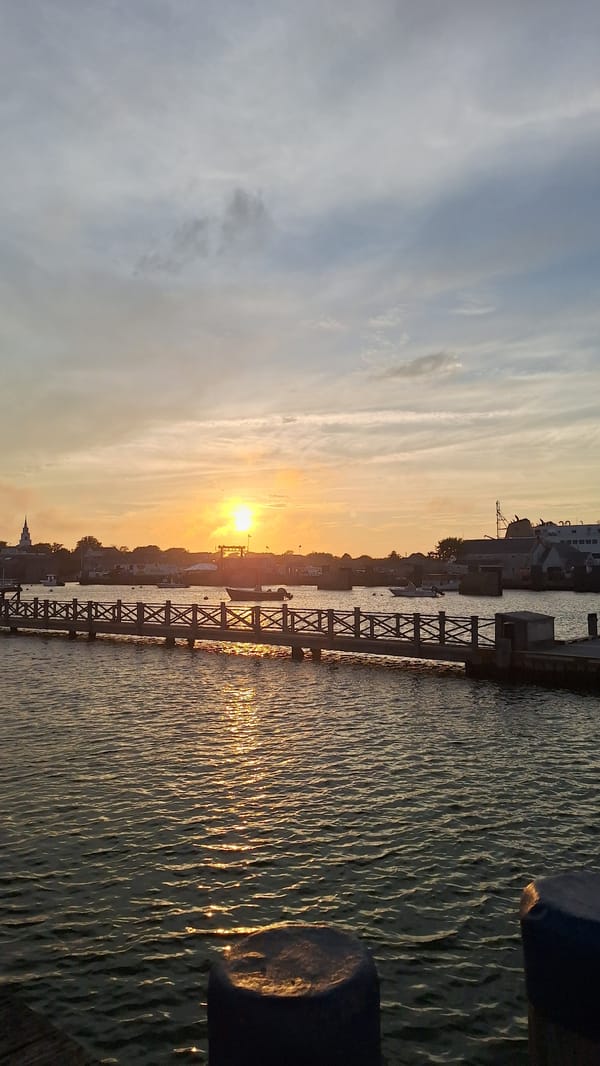Nantucket marina at golden hour, yachts and piers