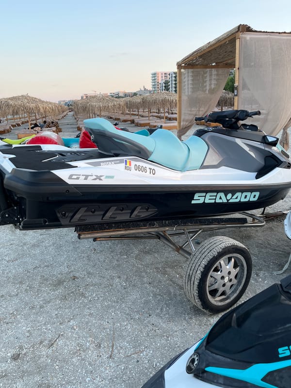 Sunset on a Năvodari beach, jet skis parked, day winding down