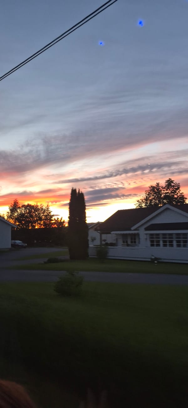 Vivid sunset sky over a residential area in Biri, Norway