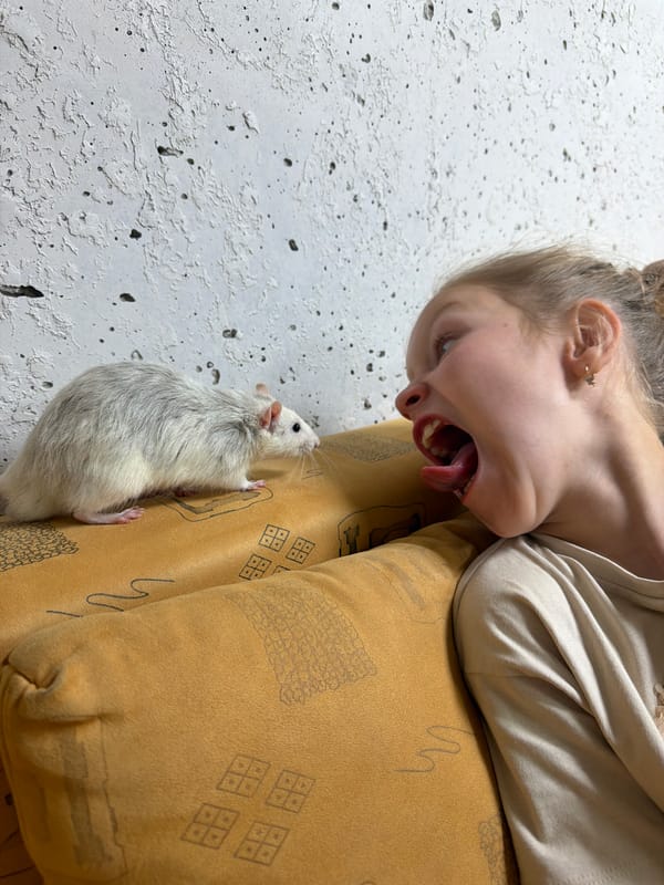 Girl plays with pet rat in Russian home