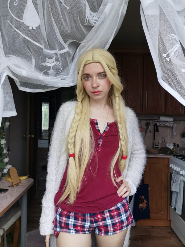 Woman poses for kitchen photo session in plaid outfit