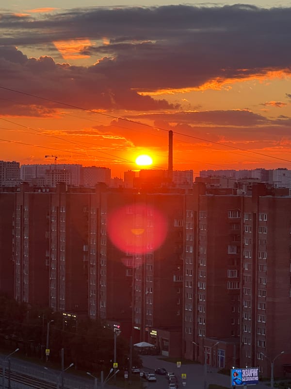 Sunset over a Russian city, tram in the streets below