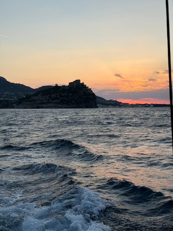 Sunset captured along Ischia coastline showing dusky sky silhouettes