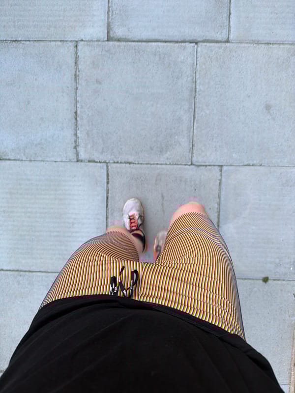 Person photographed near building with arched window in London