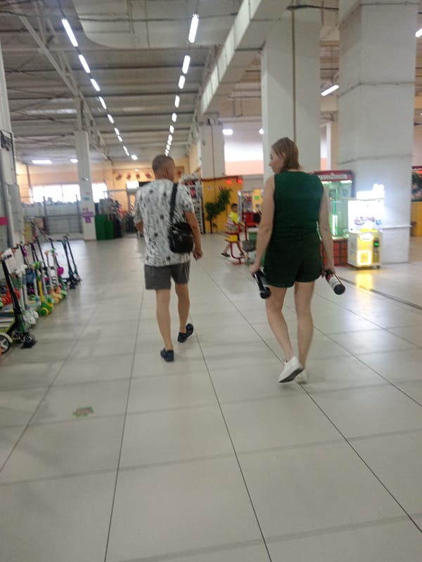 Browsing a Belogorsk shopping complex on a rainy summer morning