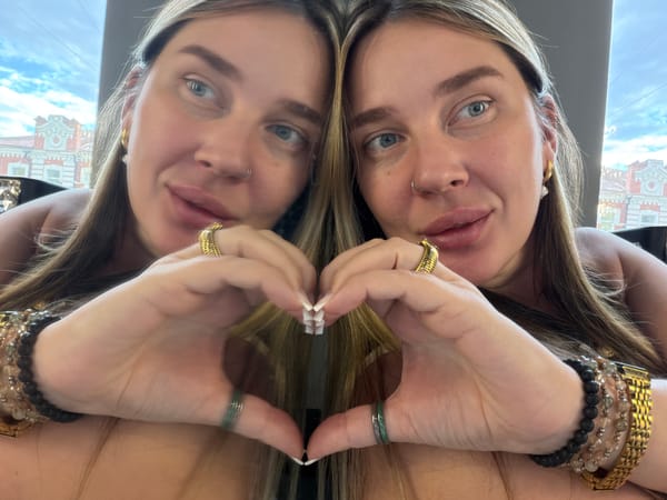 Woman makes heart gesture in mirror selfie in Shcherbinka