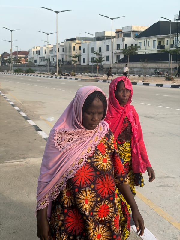 Women lying on roadside concrete observed in Alaguntan, Nigeria