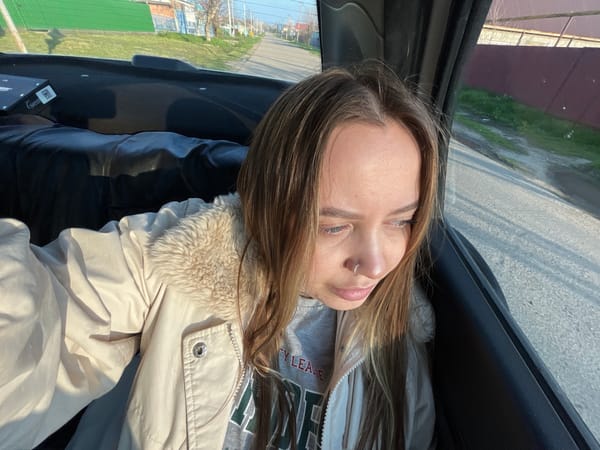 Woman photographed in car during afternoon in Novopokrovskaya