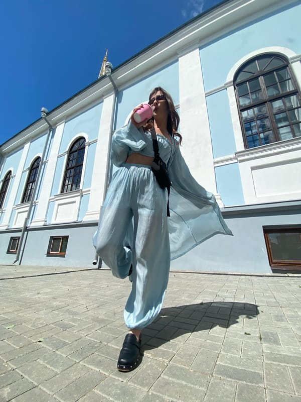 Morning moments: Woman in blue, cat indoors in Votkinsk